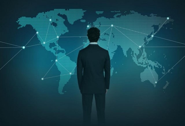 A person in a business suit looking at a computerized map