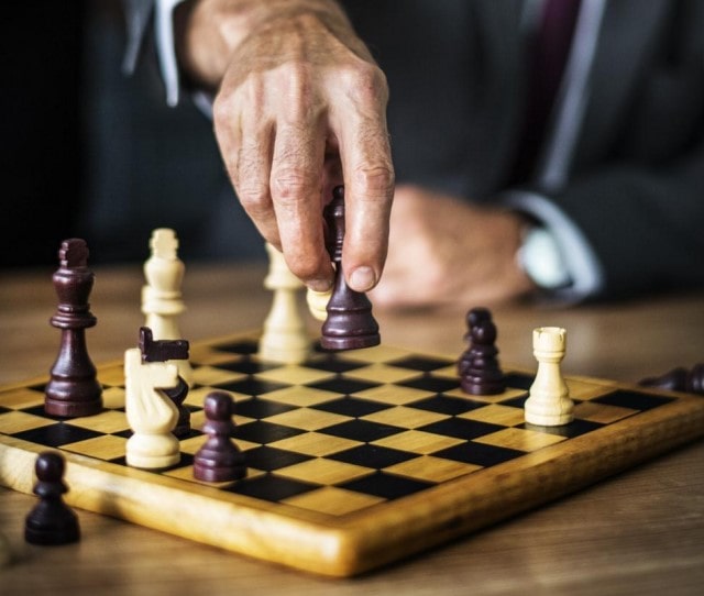 Chess player sizing up the board before moving their piece