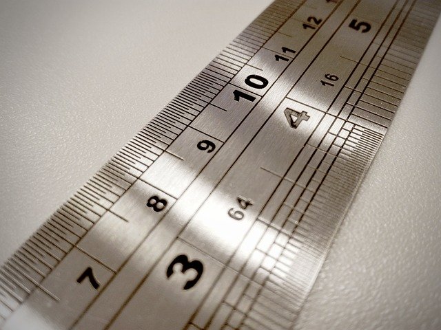 A metal ruler displaying measurements in different units