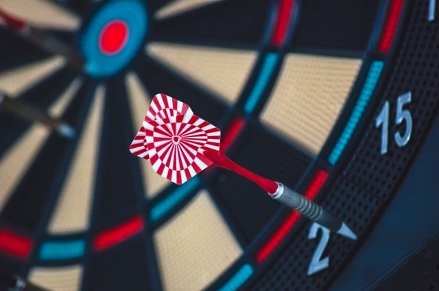 A dartboard with a dart that clearly missed the target