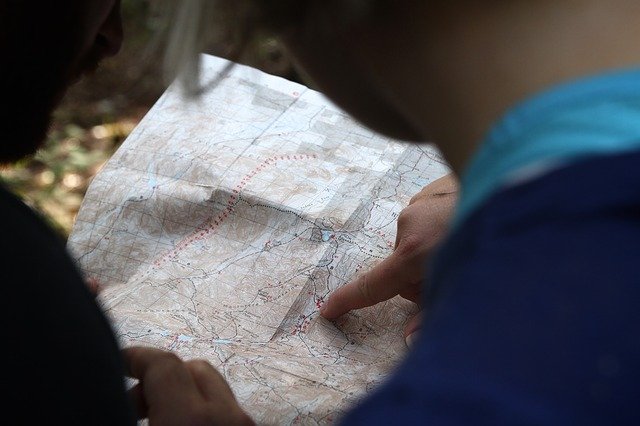 Person pointing at a topographical map